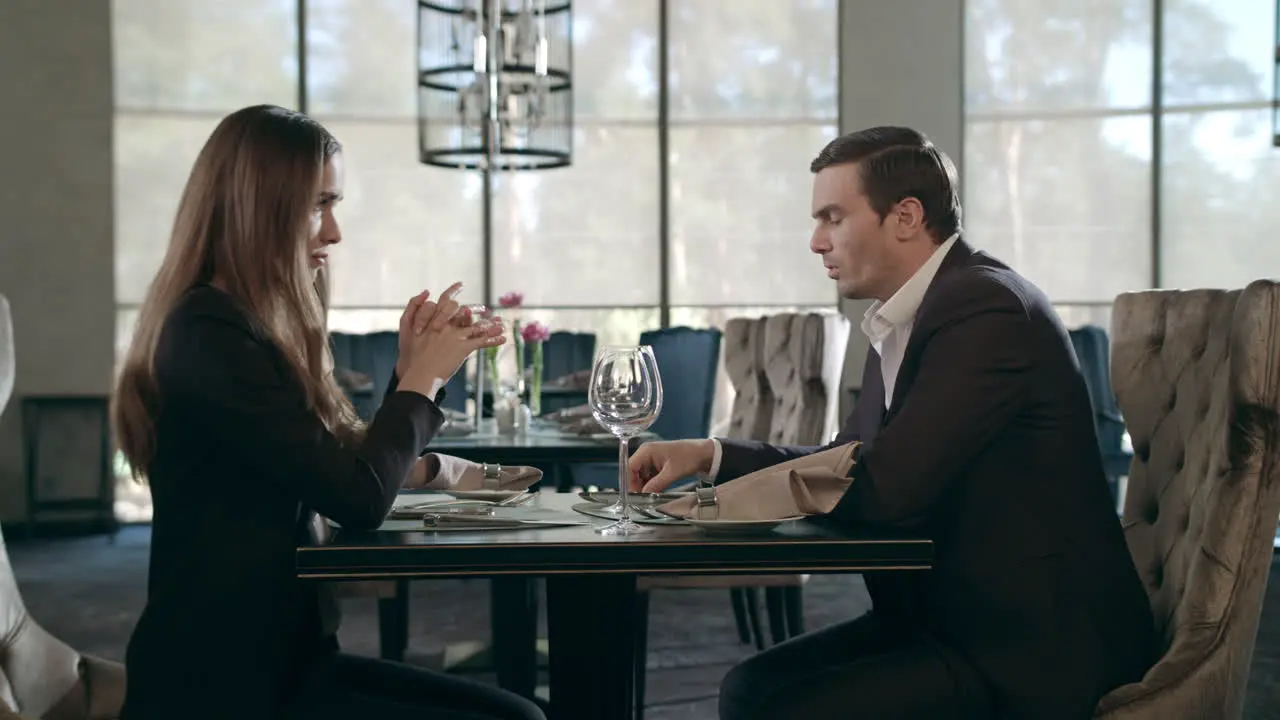 Young couple meeting at restaurant Business man and woman talking at cafe table