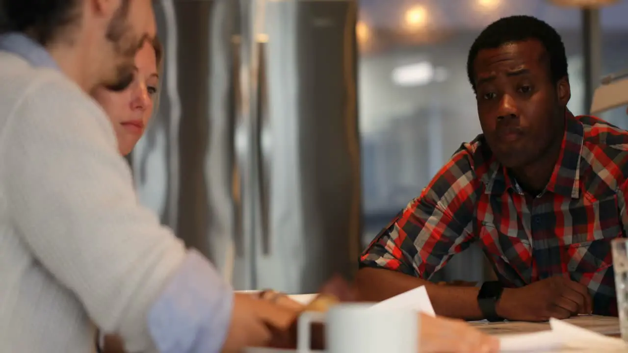 Business colleagues discussing over document in conference room 4k