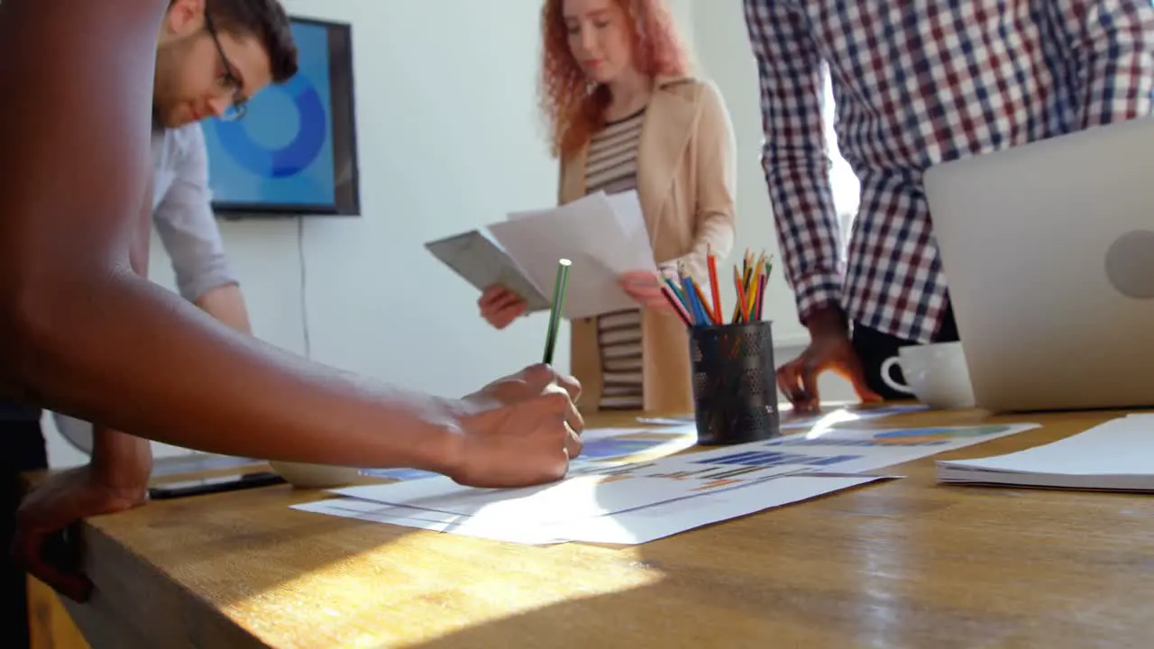 Low angle view of young mixed-race business team working in meeting room of modern office 4k