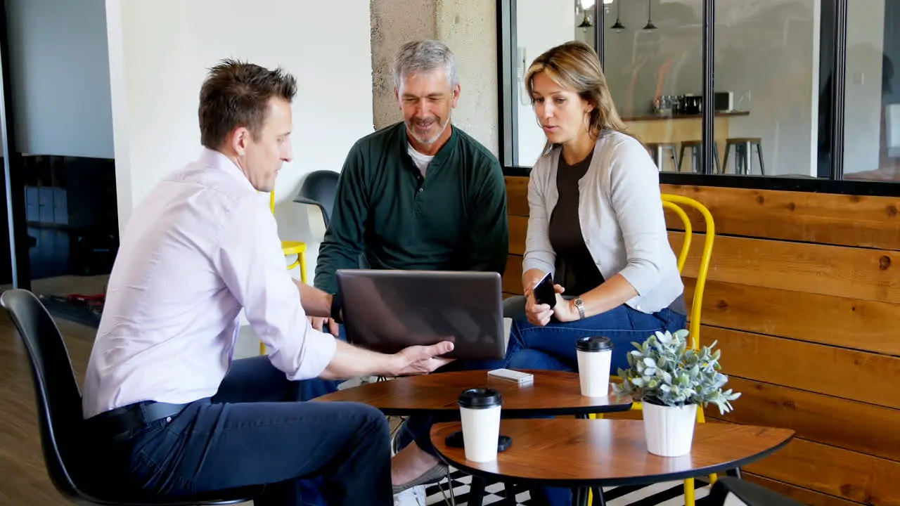 Executives discussing over laptop 4k