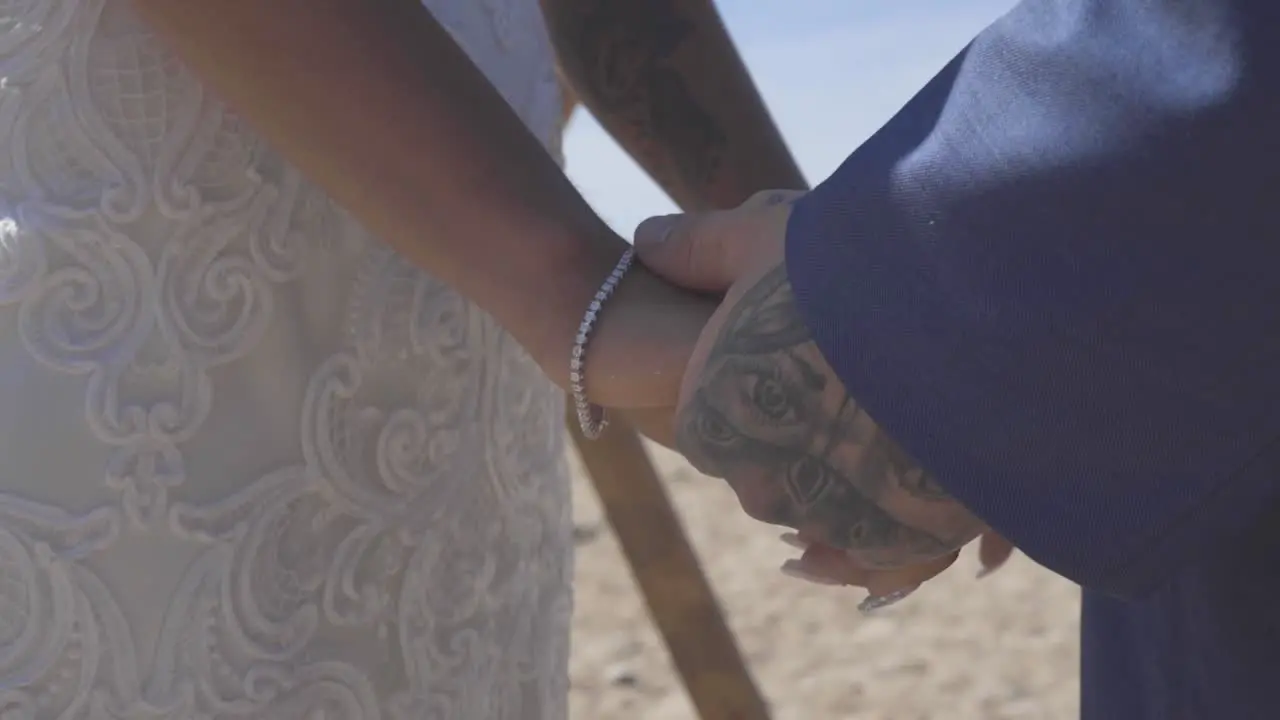 Bride and groom holding hands at ceremony