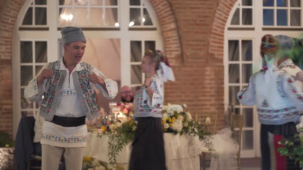 Traditional Romanian dancers perform at a party