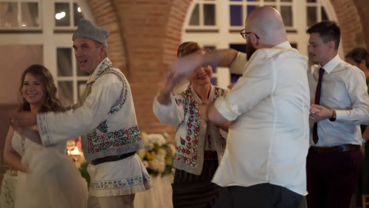 Guest dance with traditional dancers at wedding party