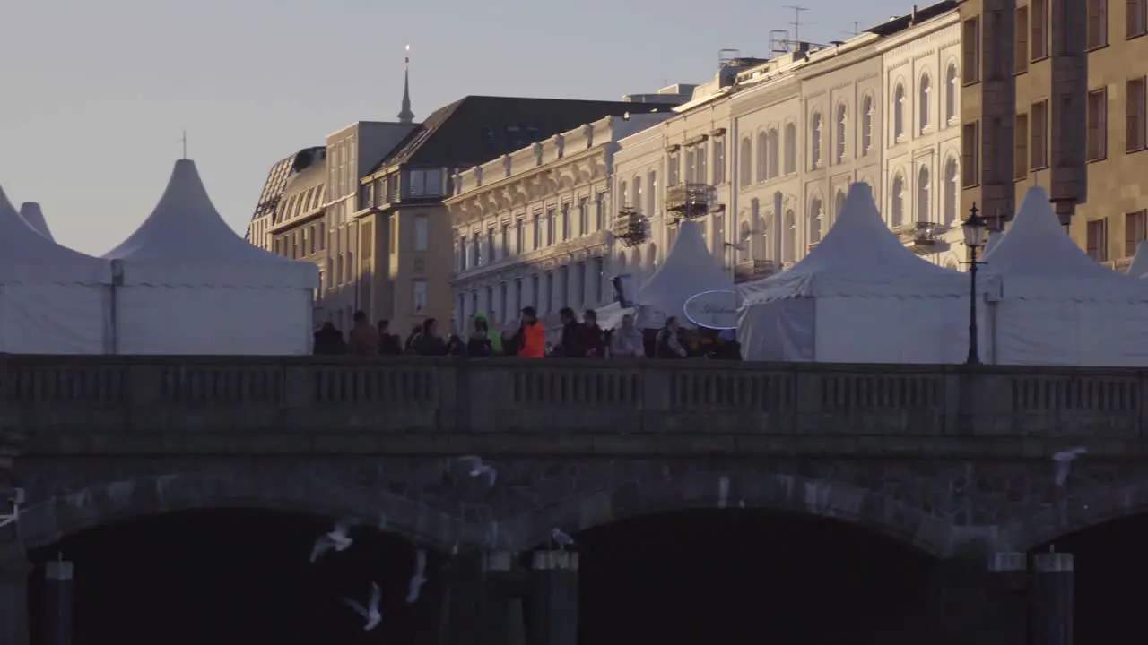 Panning view of the Christmas market near sunset at Binnenalster in Hamburg Germany in Dec 2019