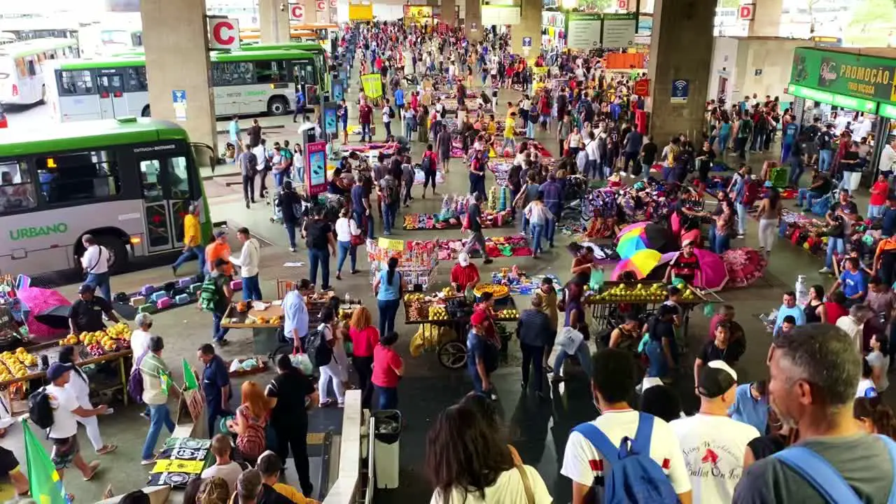 Crowd of commuters and travelers walking at a bus terminal station in Brasilia Brazil