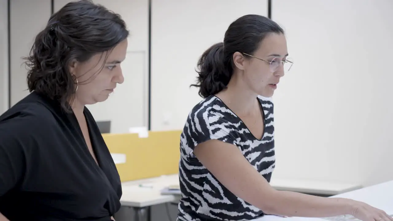 Slow motion orbiting shot of a group of coworkers working together on a project