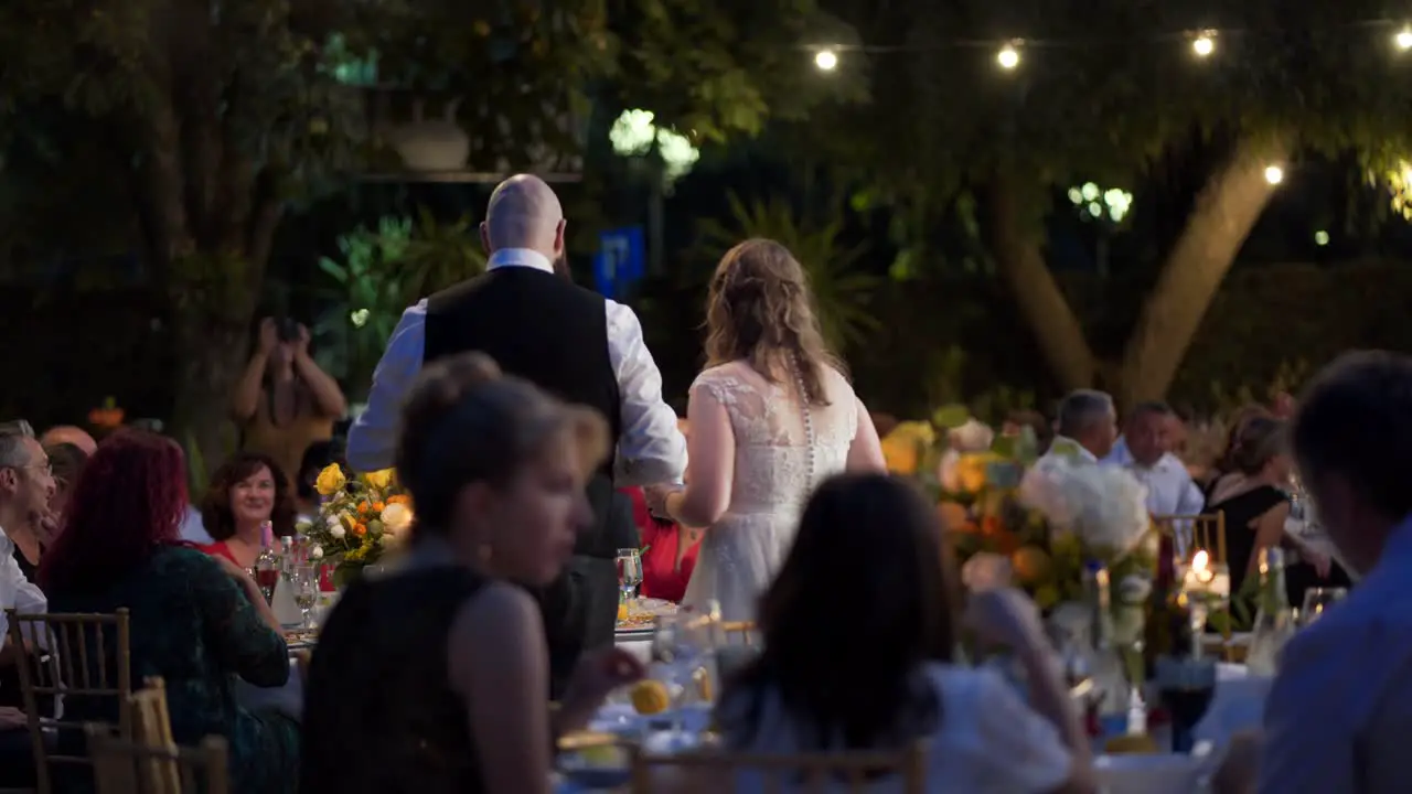 bride and groom talking to guests at a wedding party