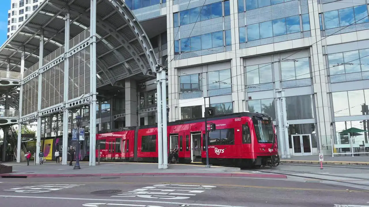 Public transport tram people and cyclists Downtown San Diego with toll buildings