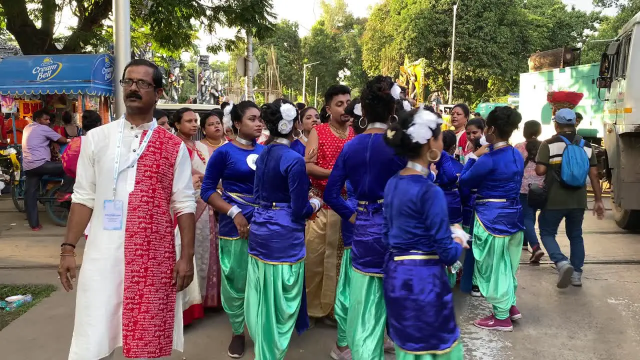 Numerous teenage girl standing in group and getting ready to perform in Red Road immersion rally before Durga Visarjan