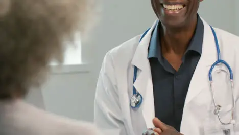 Mid Section Smiling Doctor Talking to Patient