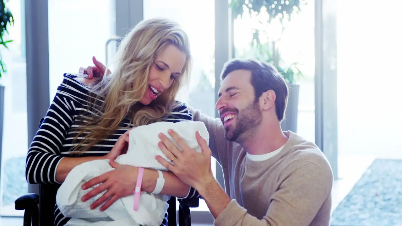 Couple looking at their newborn baby