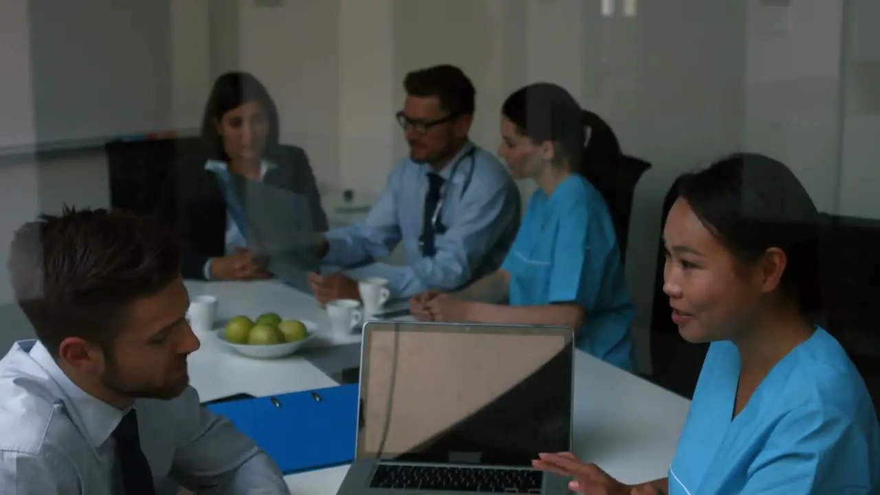 Doctor interacting with colleagues in meeting