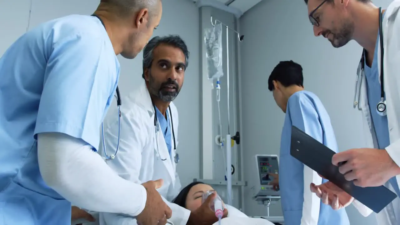 Group of doctors working together on a patient in hospital bed 4k