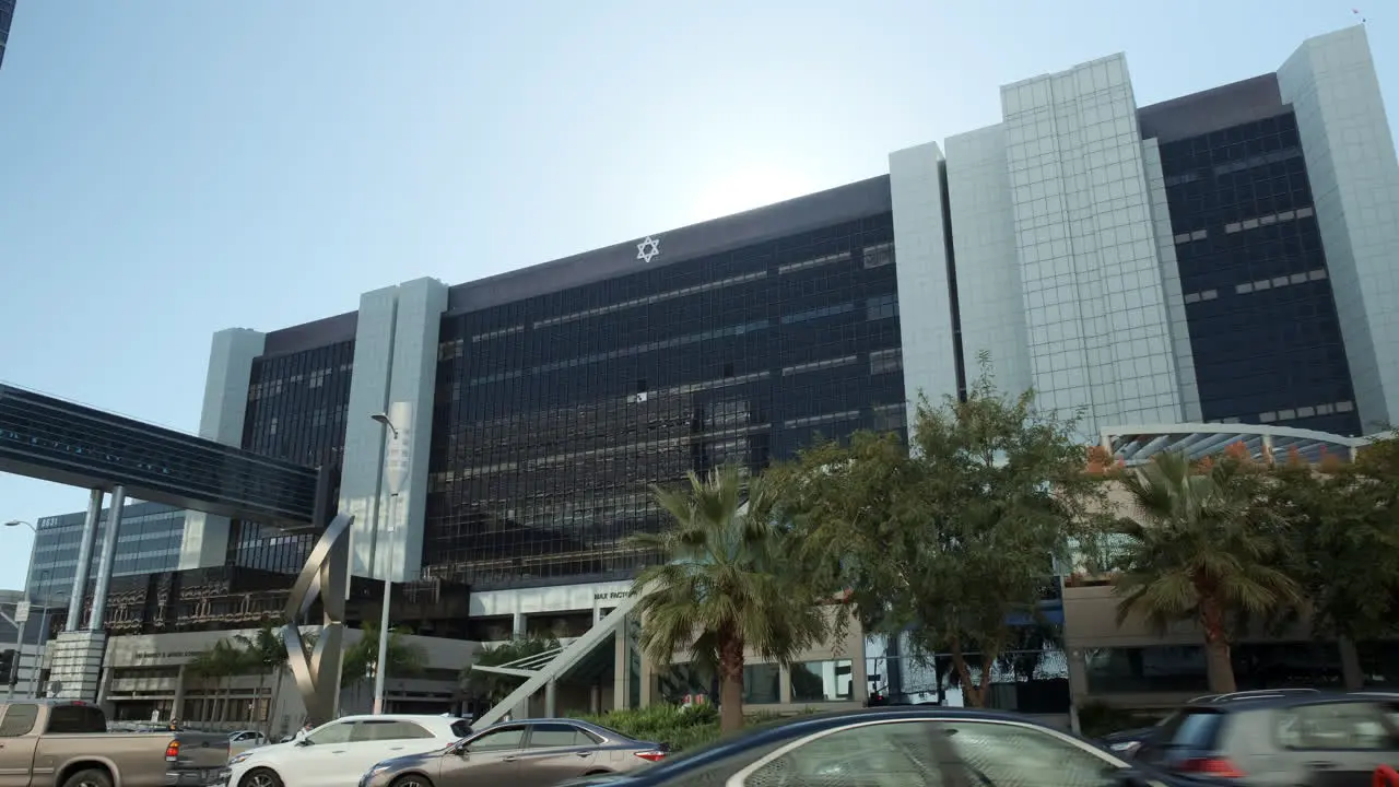 Expensive healthcare hospital building amidst busy city of Los Angeles wide shot