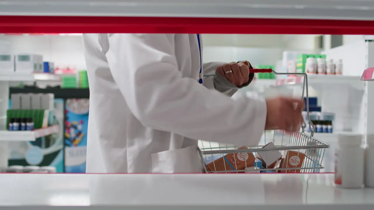 POV of medical employee placing all medicaments in boxes or bottles