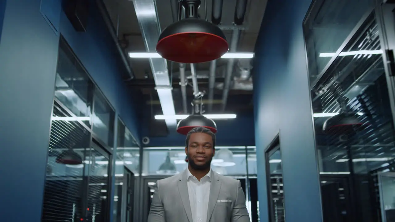 Friendly afro man looking at camera in office Businessman waiting for meetup