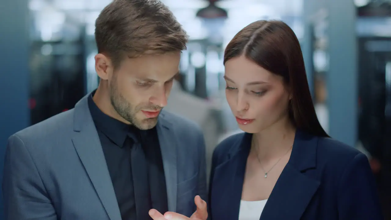 Young business couple talking over plan in office Colleagues discussing project