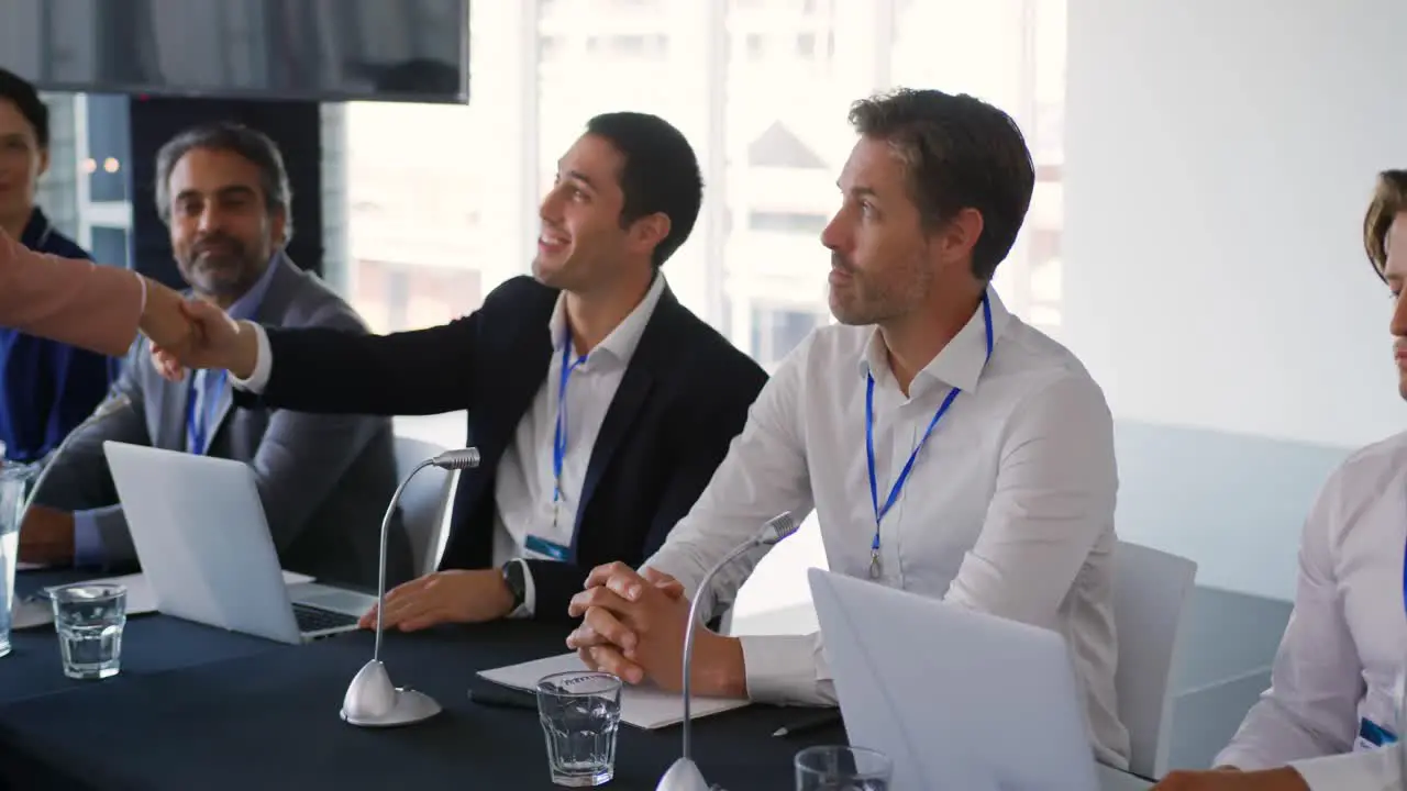 Business delegates shaking hands at a conference