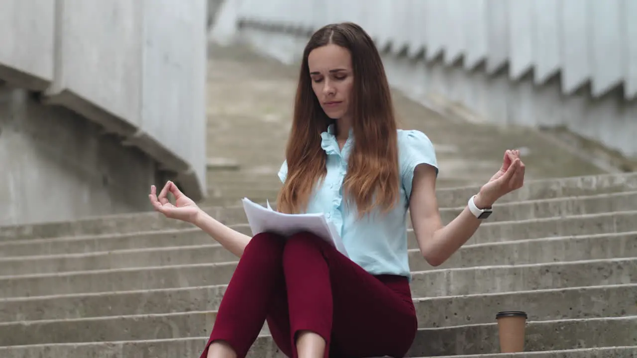 Businesswoman meditating on street Business woman drinking take away coffee