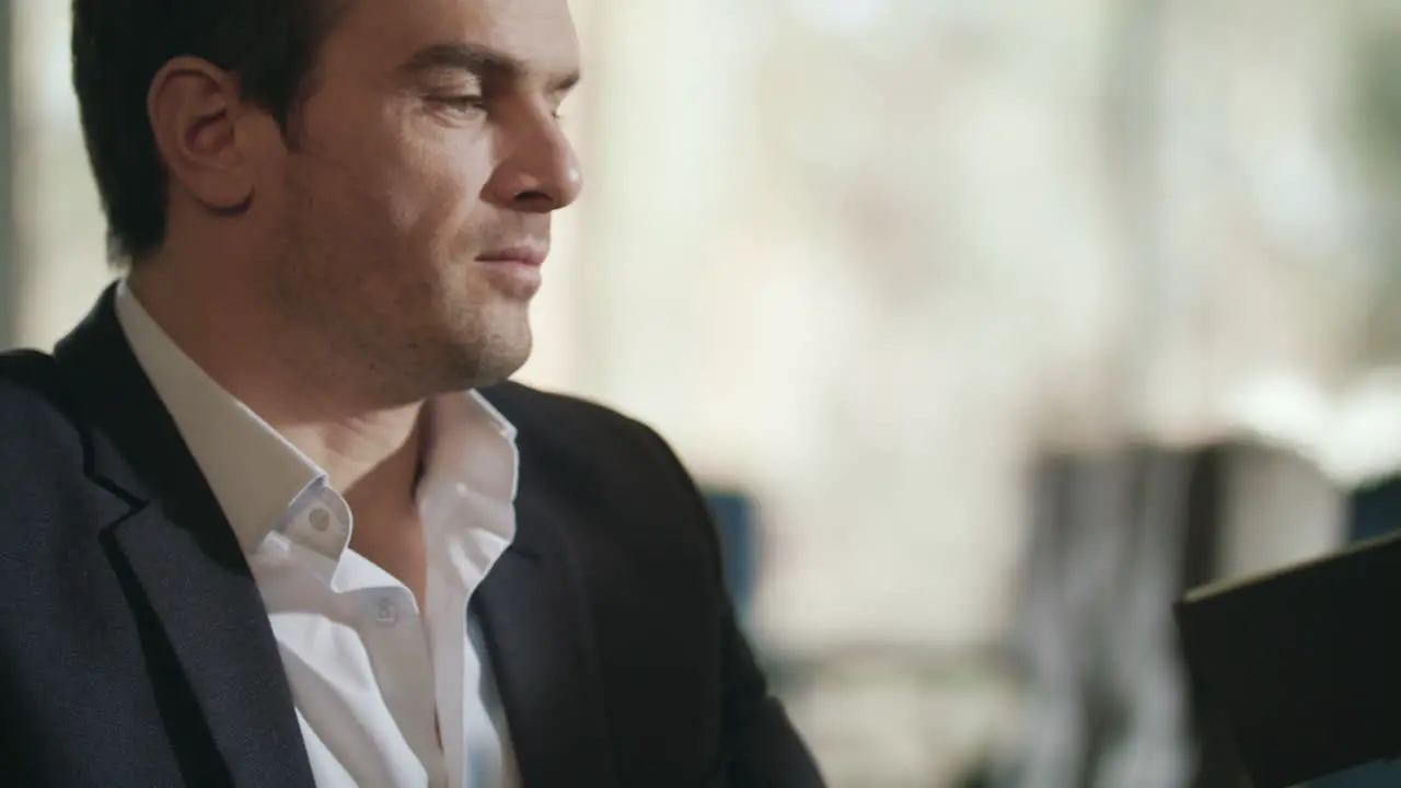 Businessman looking restaurant menu Business man choosing lunch in menu at cafe