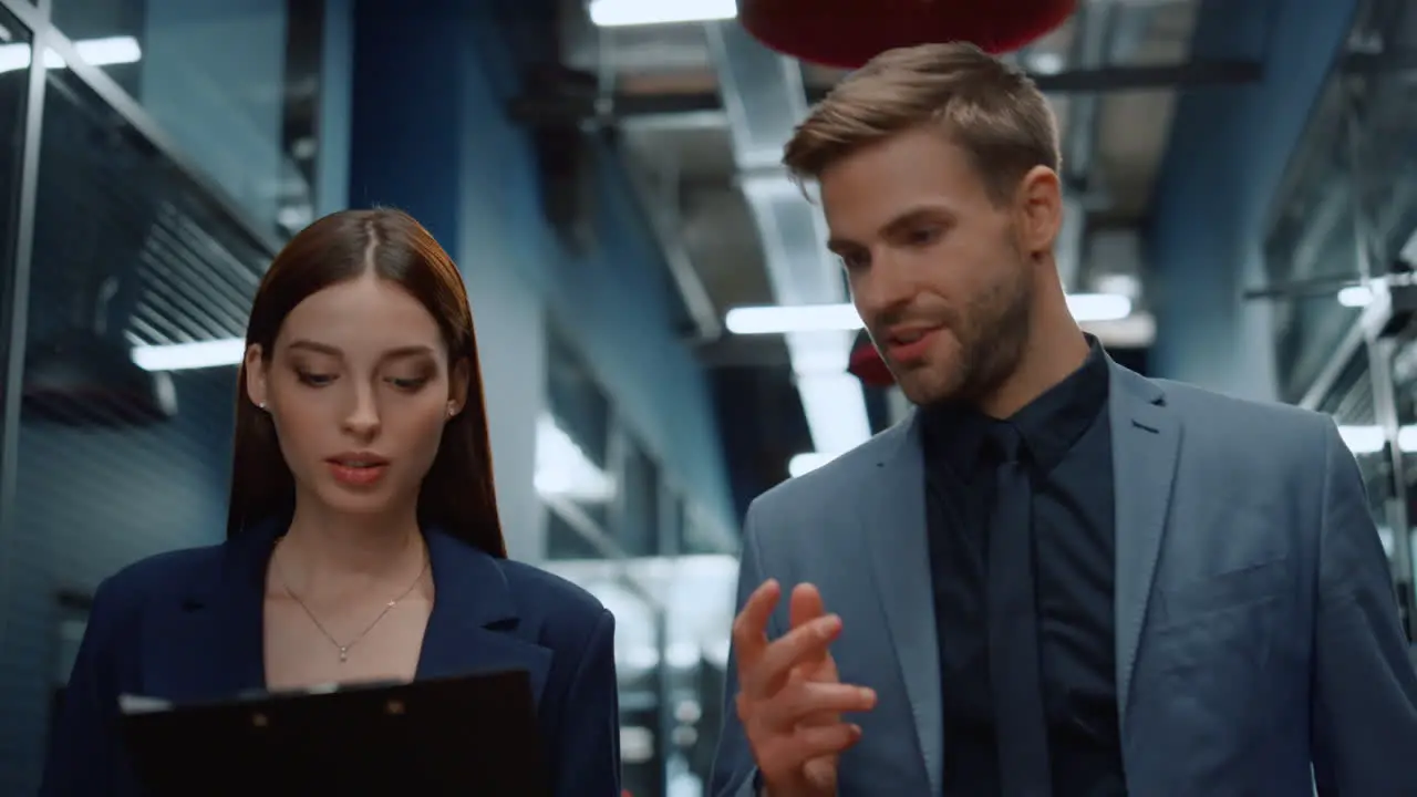 Young business couple talking in office Colleagues walking on meetup