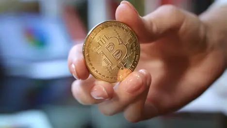 World cryptocurrency business Woman hand holding gold bitcoin coin