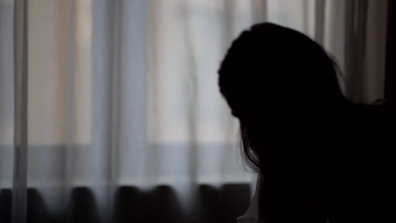 silhouette shot of a bride standing on a chair