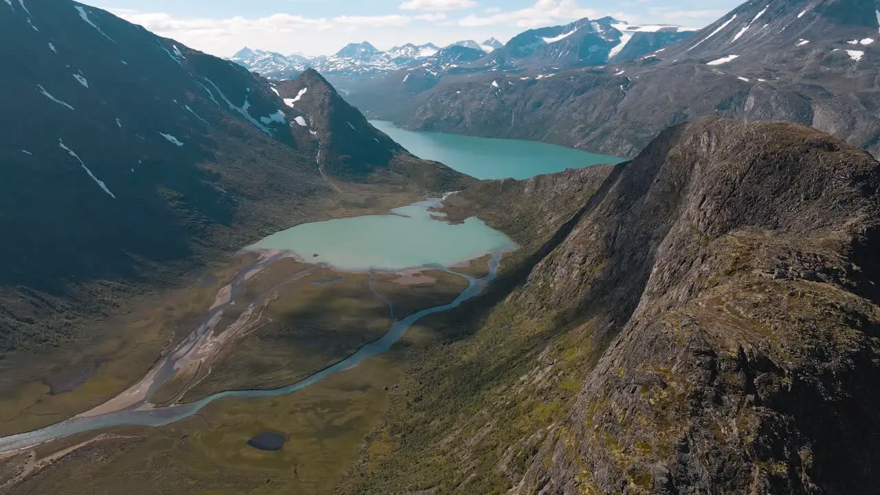 A river flows through the valley into the Ovre Leirungen and can be seen from the Knutshoe beautiful scenery in Norway