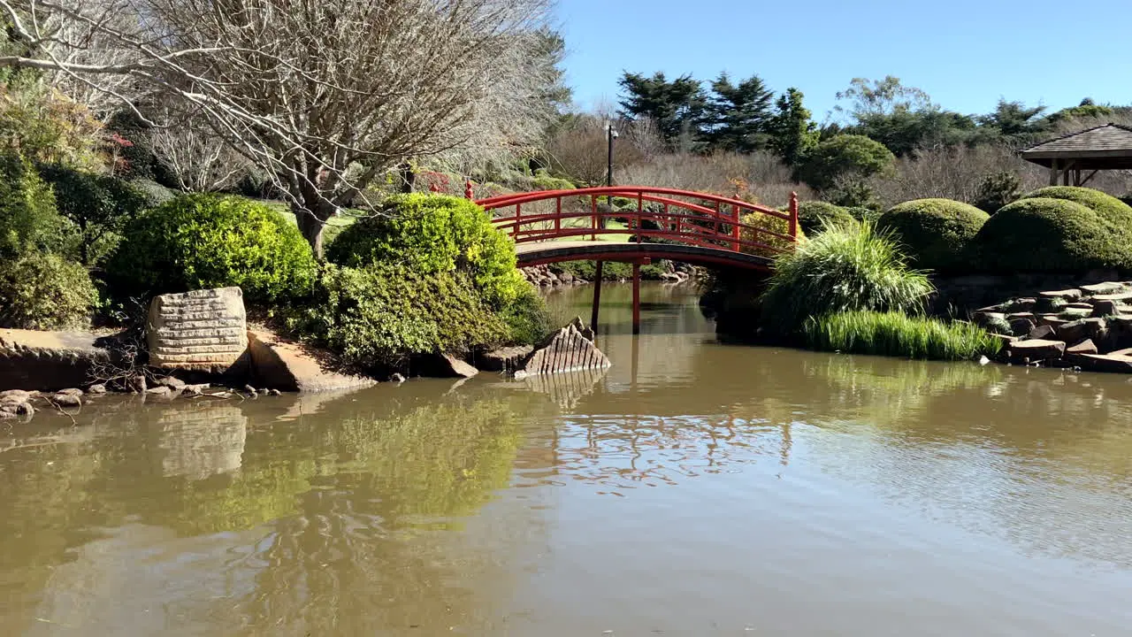 Red bridge over pond Ju Raku En Japanese Garden Toowoomba Australia