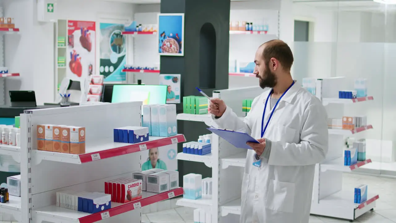 Pharmacy worker writing every medical product on inventory