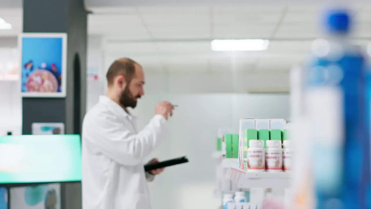 Medical worker counting medicaments boxes placed on shelves