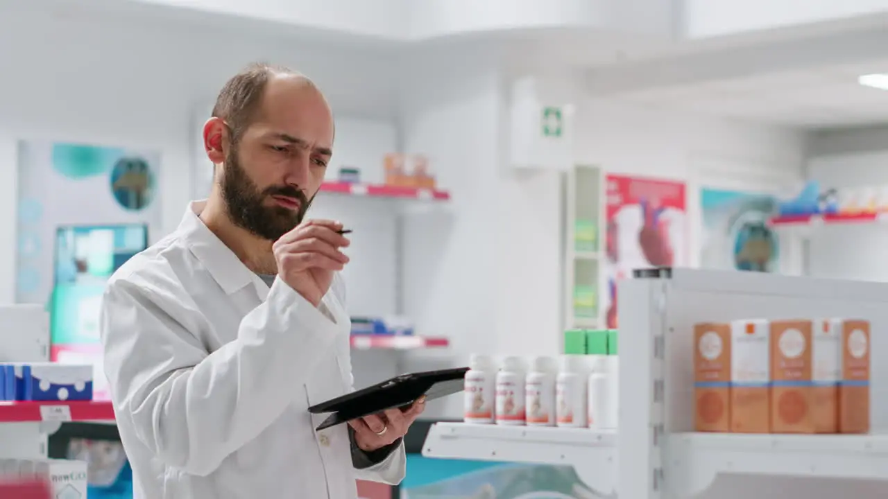 Medical employee keeps an eye on medicine boxes on shelves