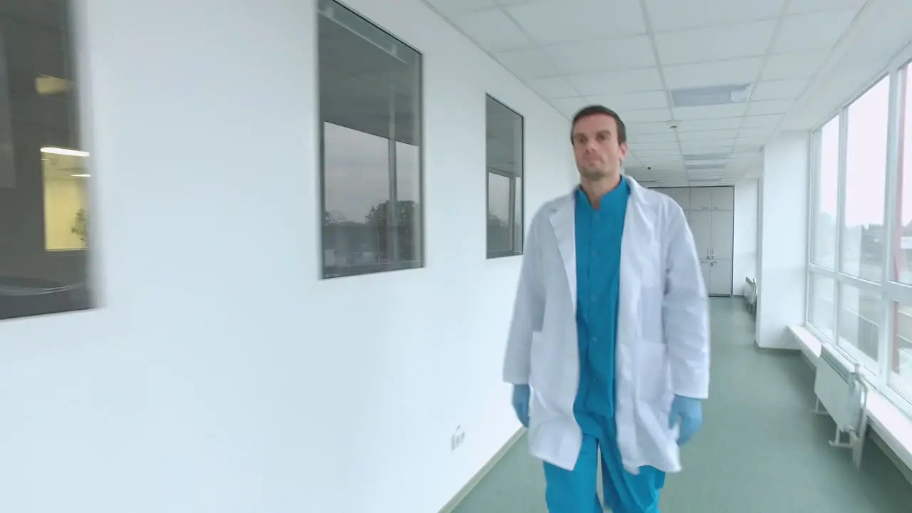 Doctor walking corridor Steadyshot of medical worker in laboratory corridor