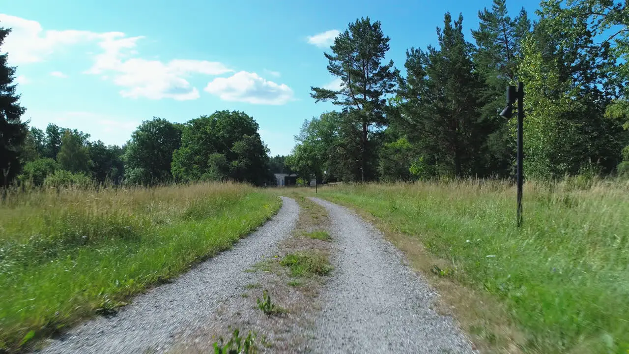 Aerial shot along a gravel path on the Swedish countryside