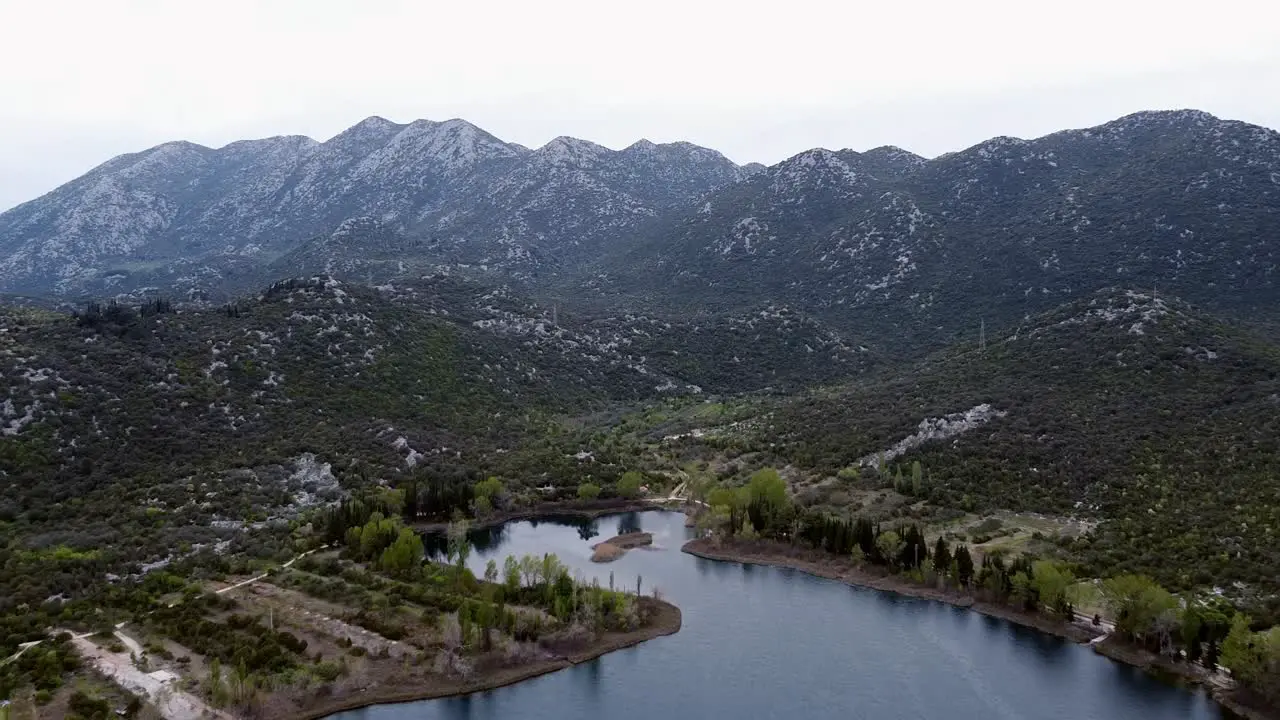 Mountains behind the lake flying with drone