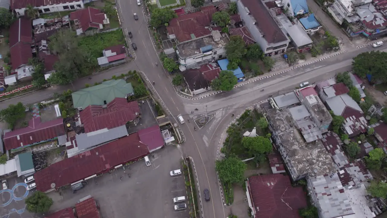 traffic driving on road through Waikaboebak city at Sumba island aerial