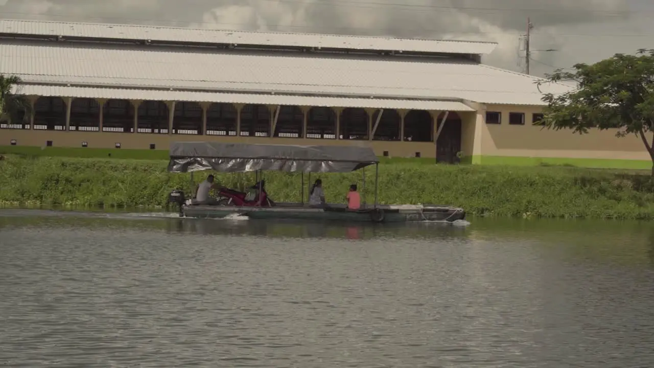 Small wooden boad cruising through a lake in Guatemala