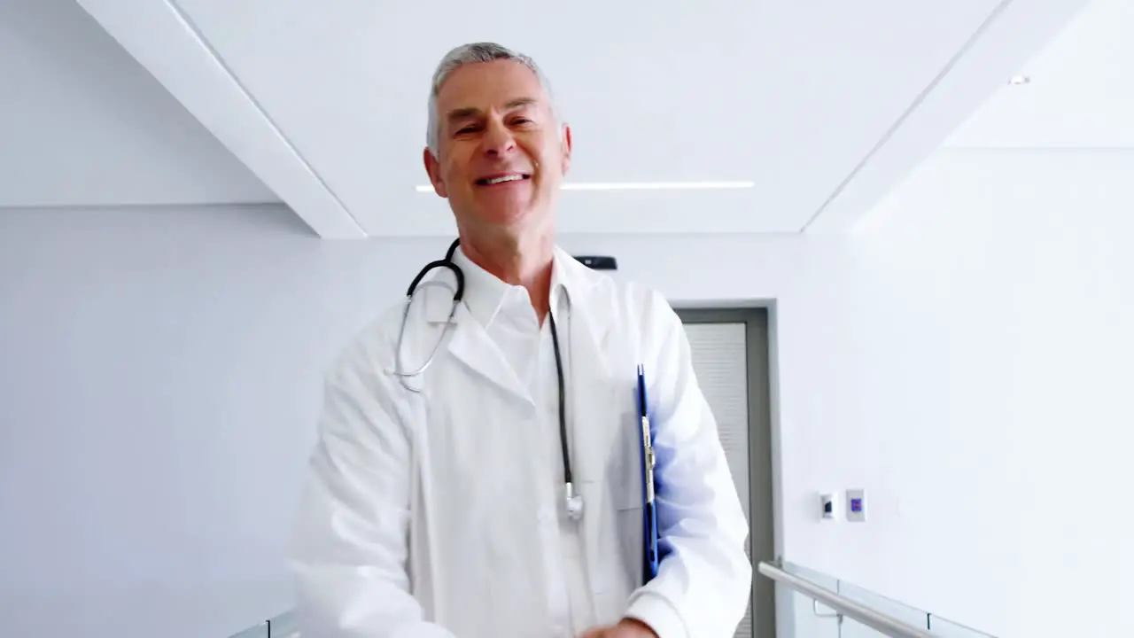 Doctor looking at medical report and smiling at camera