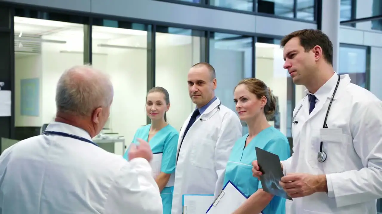 Team of doctors having a meeting in corridor