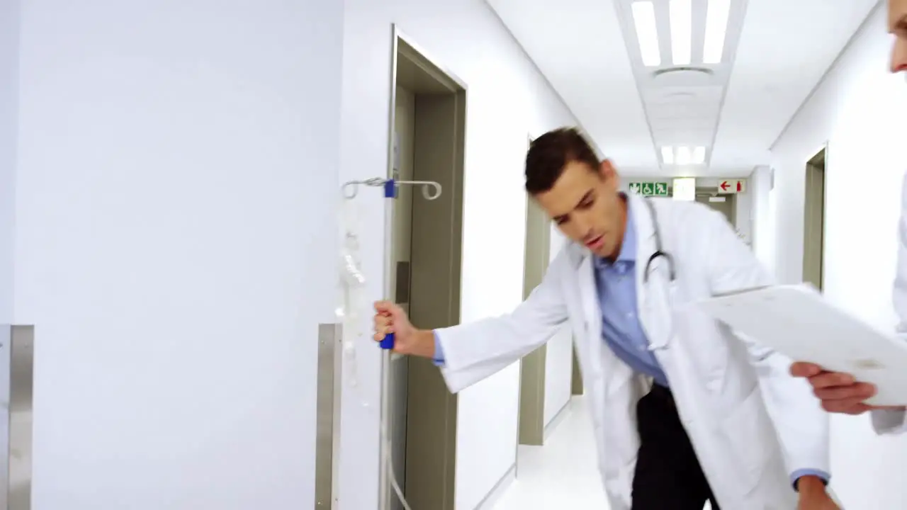 Doctors pushing emergency stretcher bed in corridor 