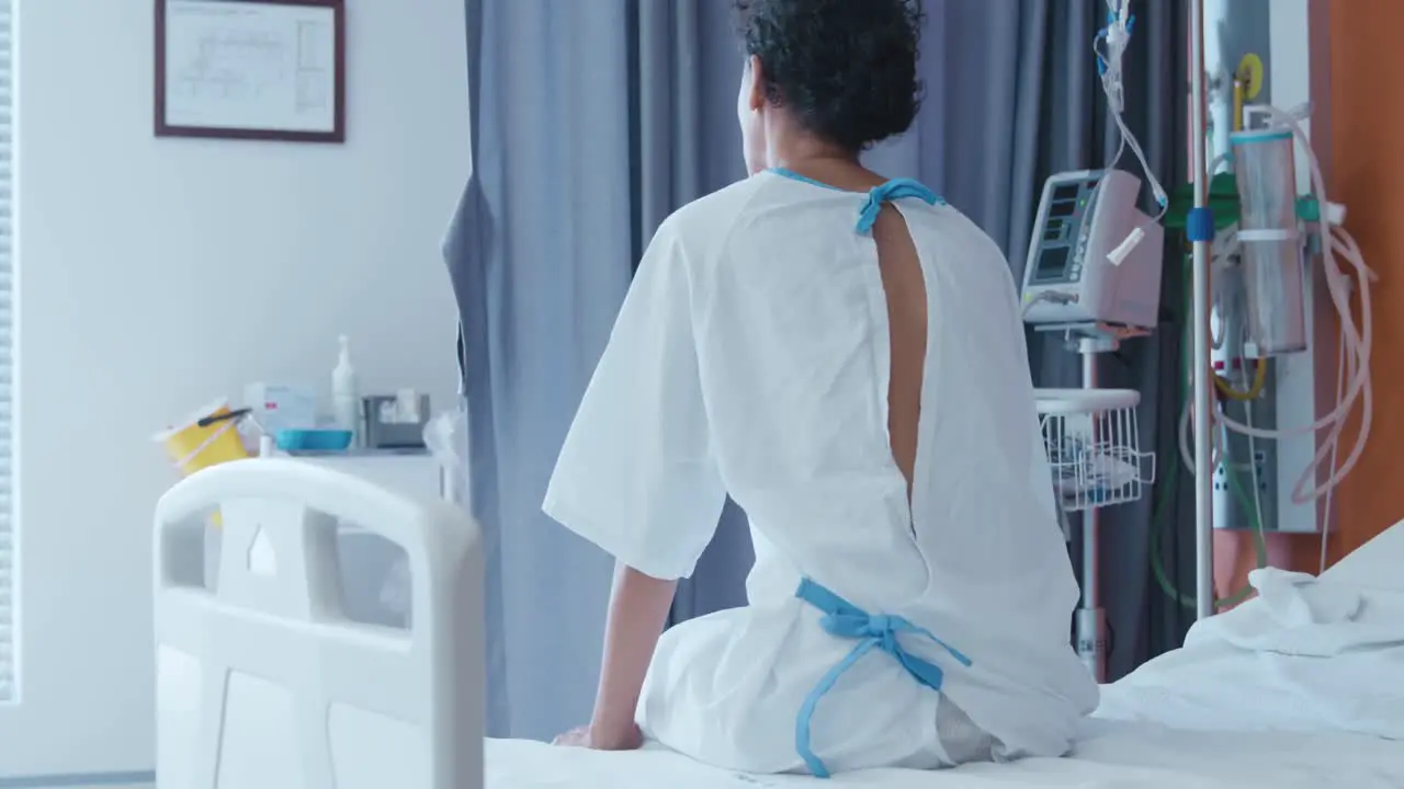 Female patient sitting on a hospital bed