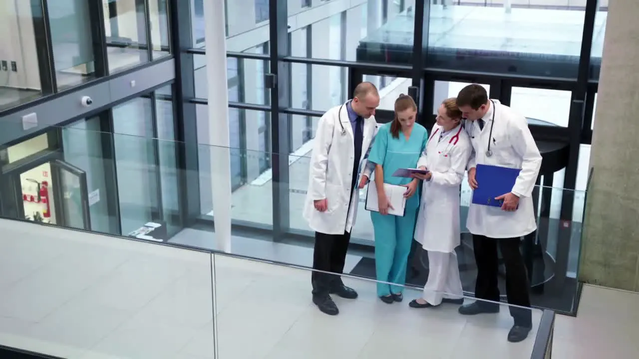 Doctors interacting with each other in corridor