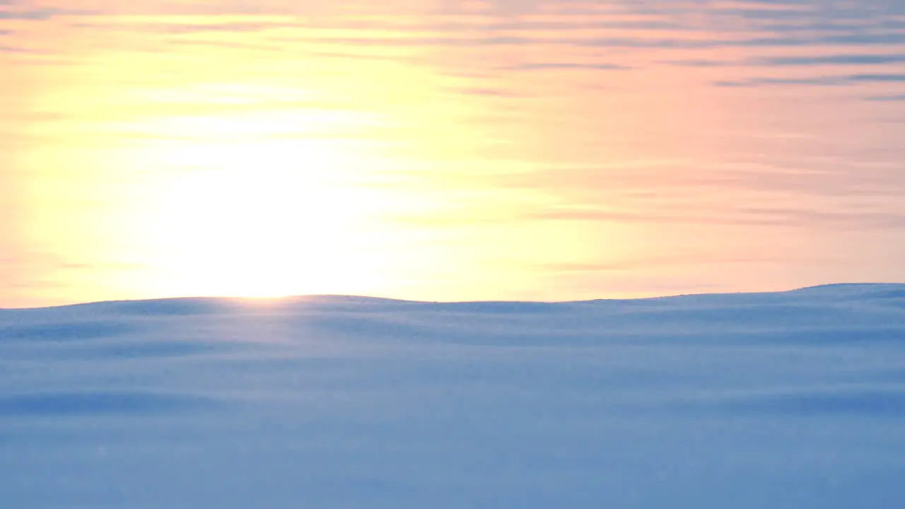 Reflection of sunlight on water and snow covered coastline