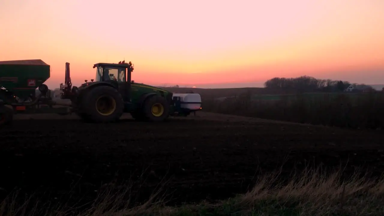 Tractor driving by in the sunset