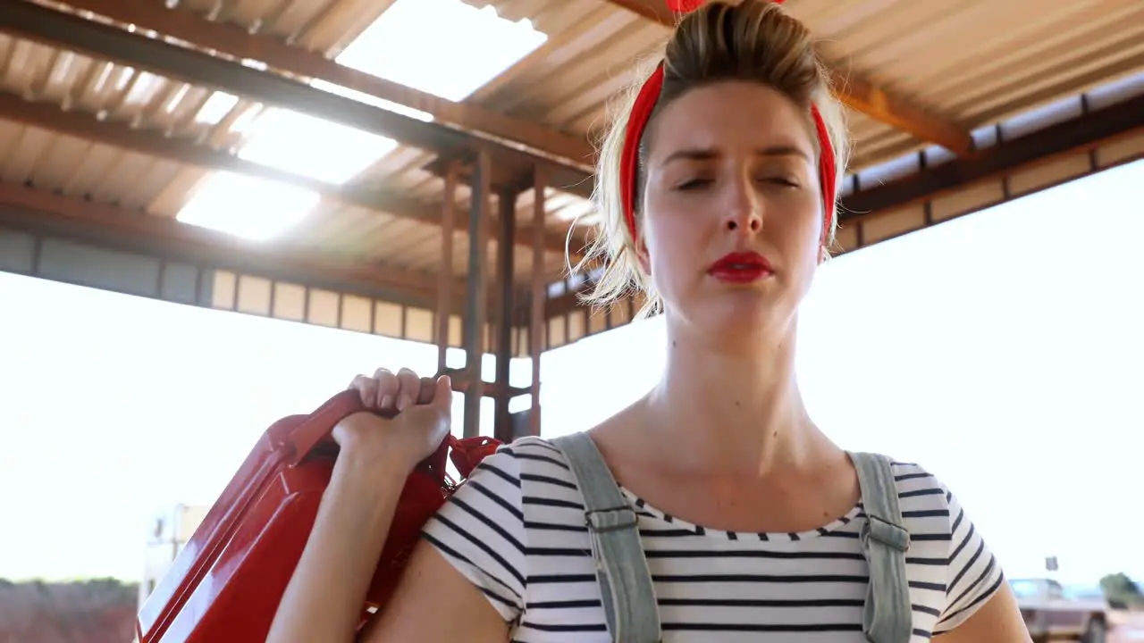 Woman holding a petrol can at petrol pump 4k