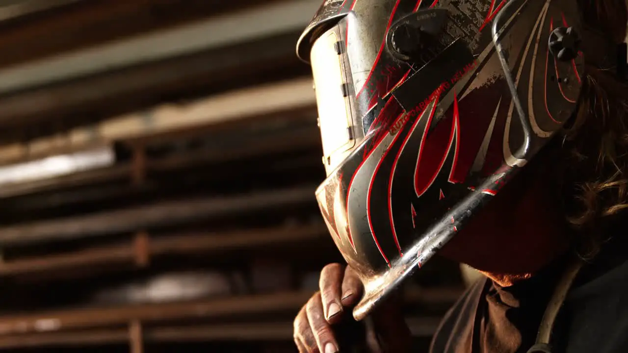 Welder wearing protective helmet