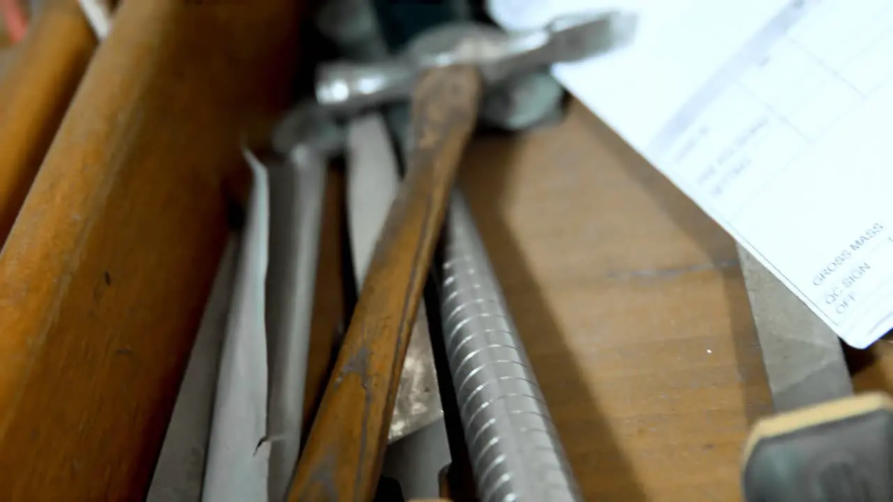 Various tools arranged on wooden table in workshop 4k