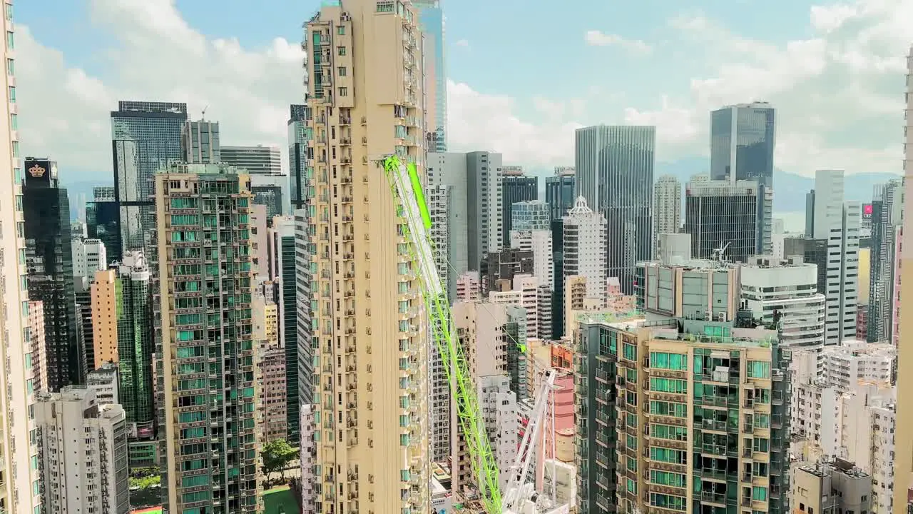 Construction crane amongst skyscrapers in Hong Kong