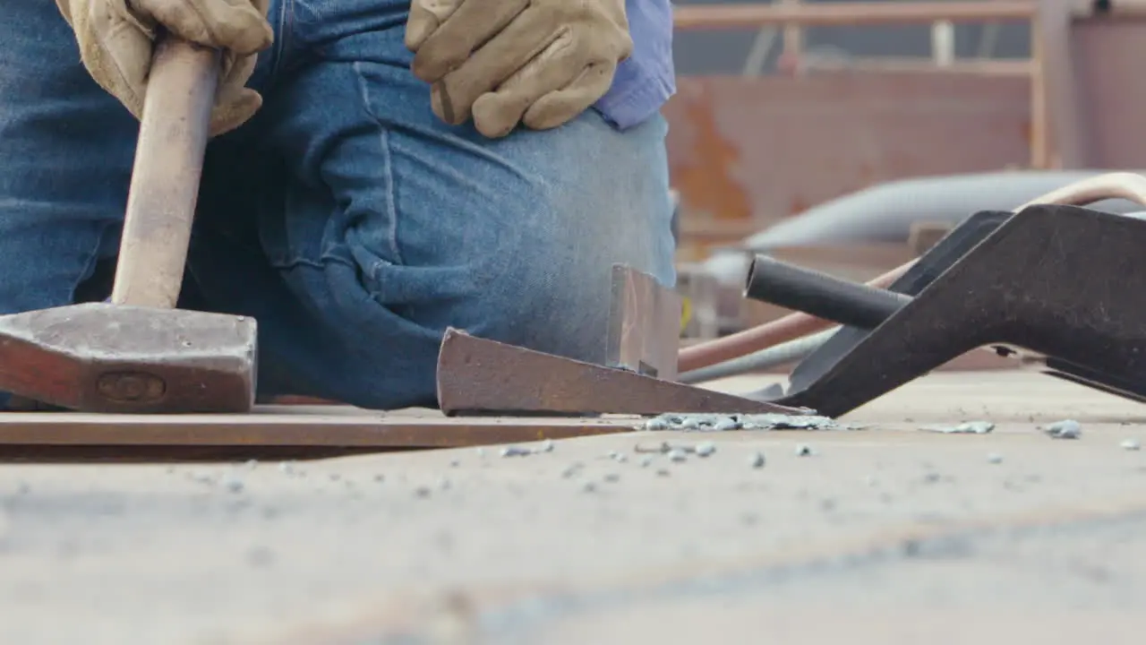 Men at work in gloves hits with a hammer