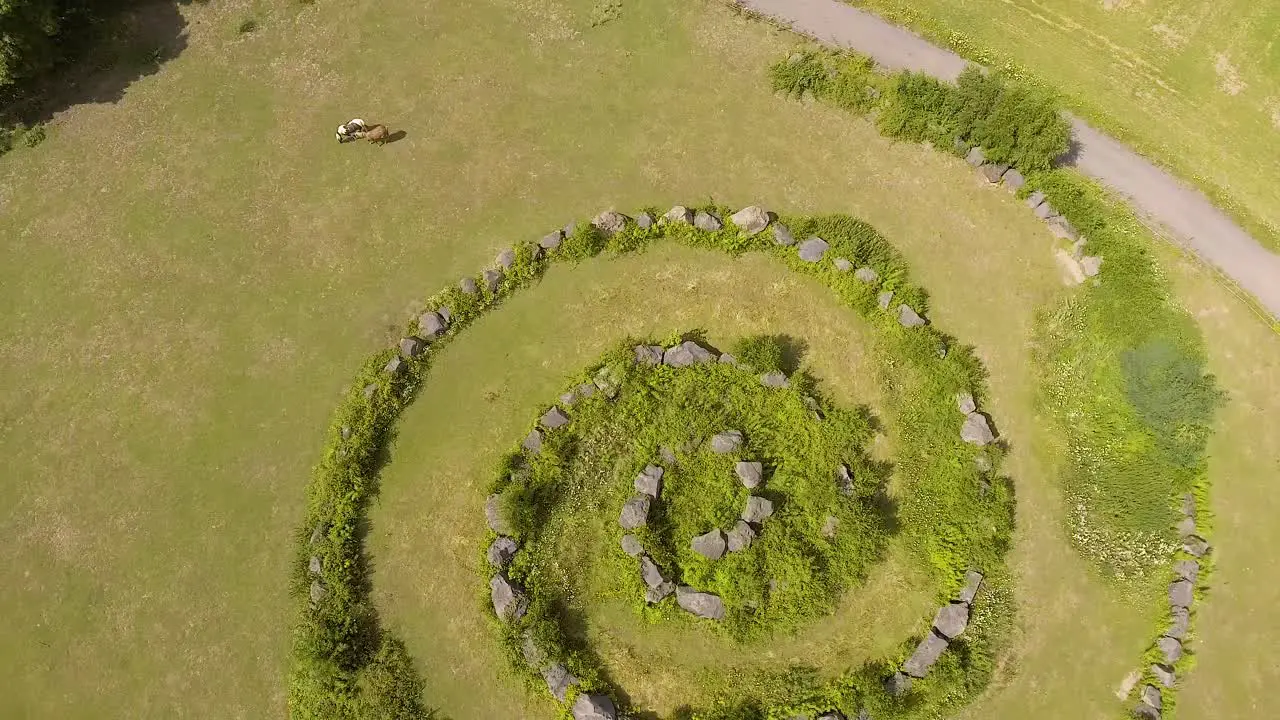 Flight up above a mysterious stone circle on a field